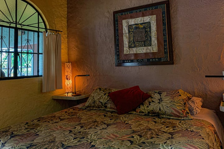 A king bedroom with air-conditioning, ceiling fan, fine linens and ensuite bath with rain shower