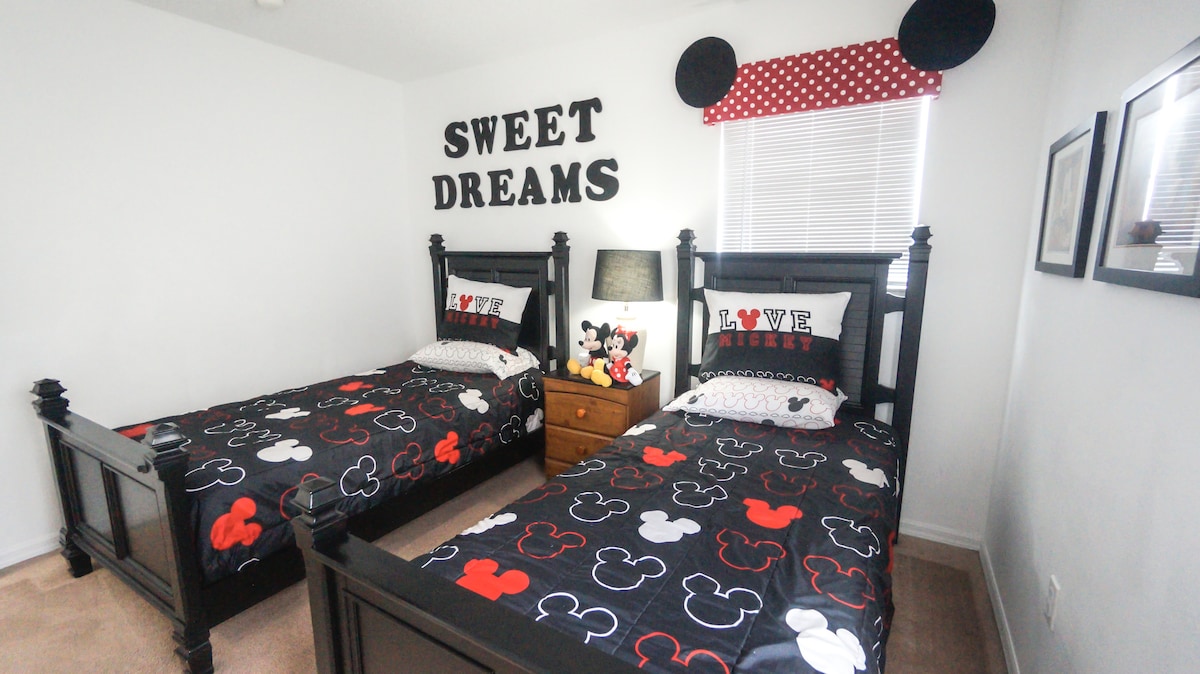 Twin Bedroom with Alexa enabled lighting. Brand new memory foam mattress toppers provided in closet (not placed on the beds due to potential child allergies.  all sheets washed and bleached after each guest stay). USB ports for all electronic devices