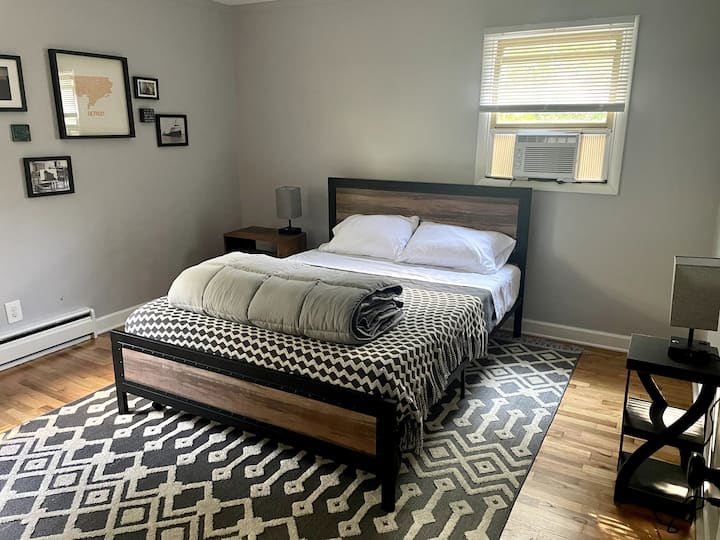 Master Bedroom - The Detroit Room. You control your own heating and cooling. There is a ceiling fan & the lights have USB-ports. It's a memory foam mattress, plus extra pillows in the closet. There is a new TV, a full dresser, and two air mattresses.