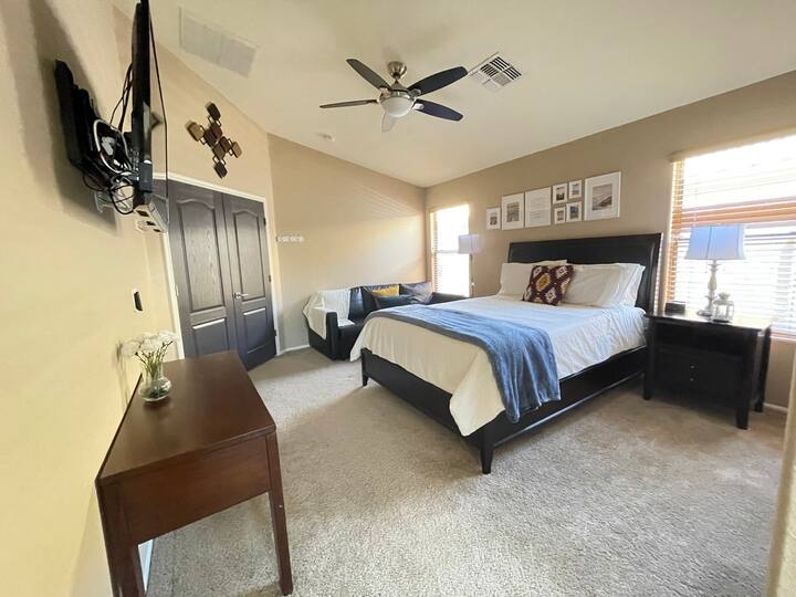 Spacious master suite with couch and TV
