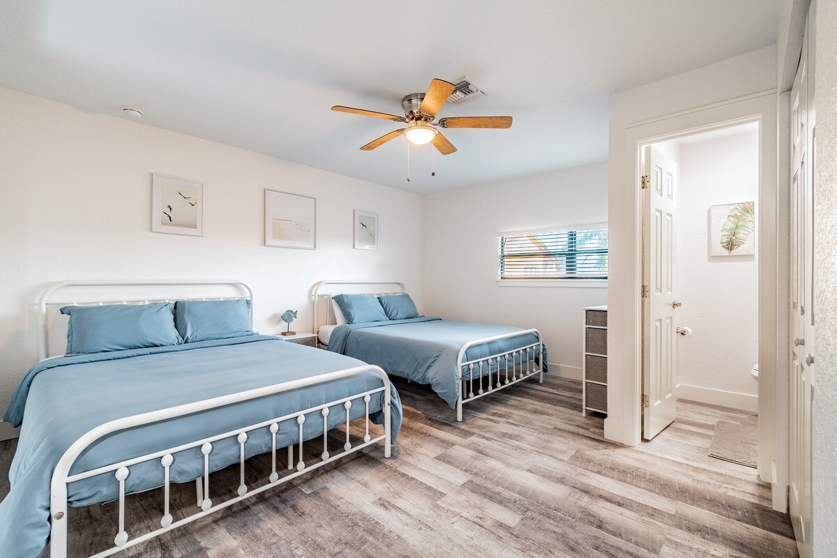 Upstairs loft with 2 queen beds and a half bathroom… PLUS a eek out the window of John’s Pass waterway!