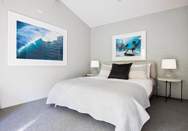 Master bedroom, featuring a local photographer’s stunning artworks.