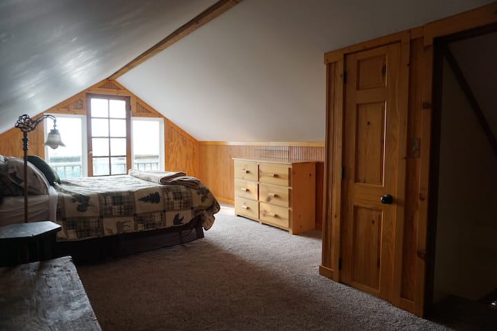 Queen bed with a deck over looking the river valley 