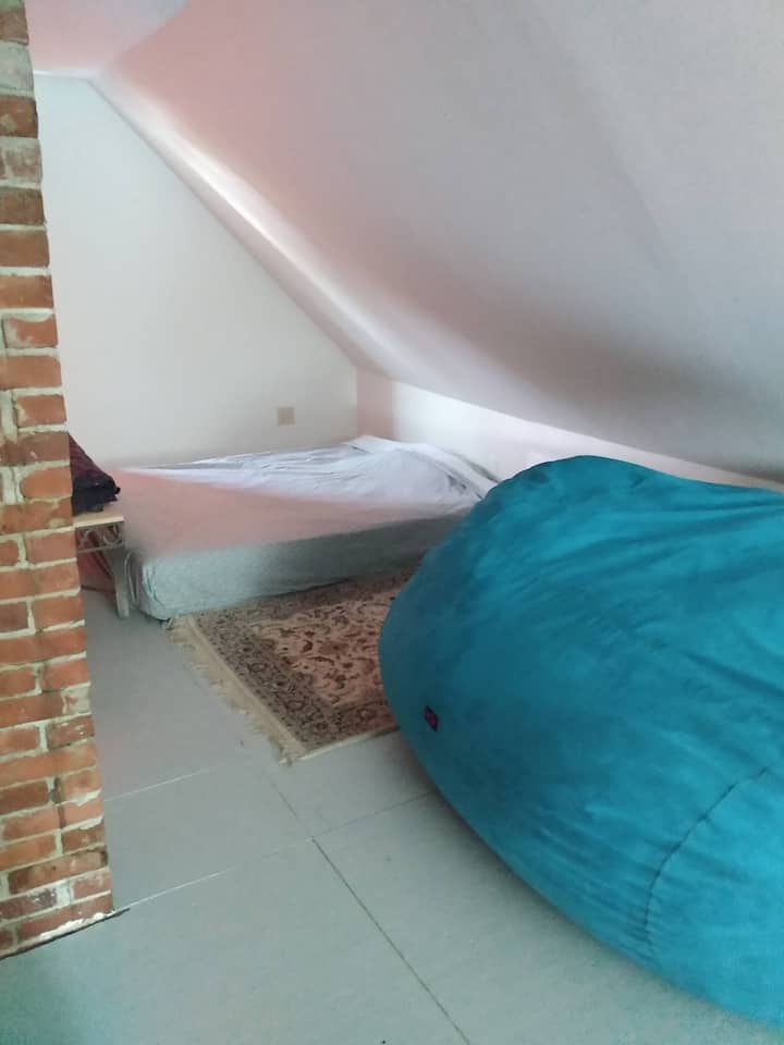 The third floors has a queen bed and a workspace with desk and printer