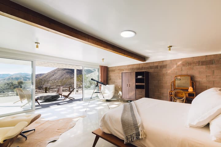 The Mallow Room (Bedroom 3) with Floor to Ceiling Glass Sliders, Kind Sized Tempur-Pedic Mattress, Mid-Century Furnishings, and Celestron Telescope for Night Sky viewing