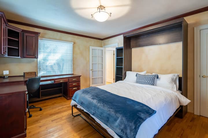 Thire bedroom with queen size bed and office space