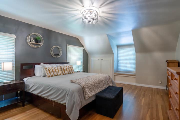 Master bedroom with king size bed and dresser.