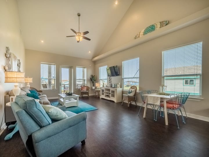 Open floor plan showing large living space with plenty of seating and ocean views. 