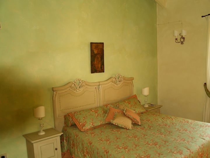 The second double bedroom, very bright and large  with two windows overlooking the olive groves, decorated in olive green.  There is also  a single extra bed  and a small children's bed.