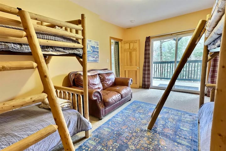 Bunk room on lower level with pond view and walkout lower deck.