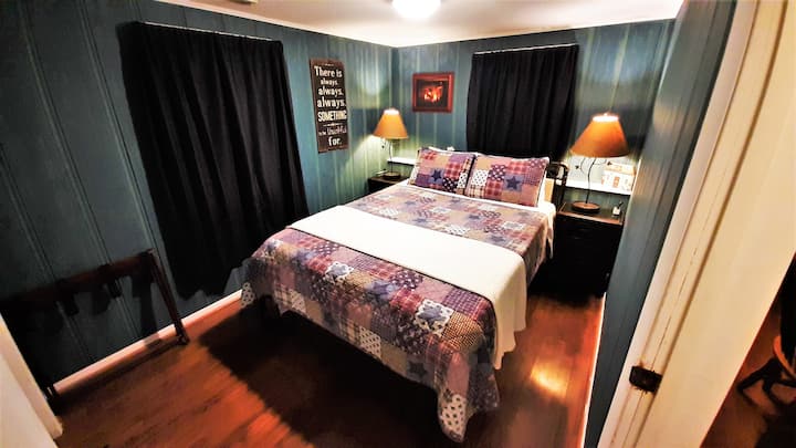 A queen bed in the front bedroom (Bedroom 1 of 2)