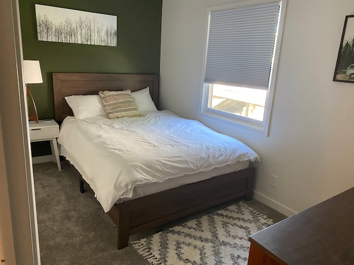 The green guest room has a queen bed with memory foam mattress topper. 