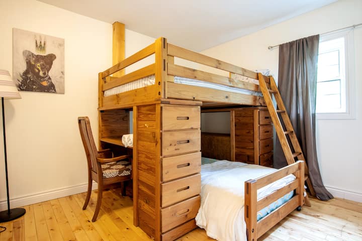 Bedroom 3, has Double and Single Bunk Beds overlooking the front yard.