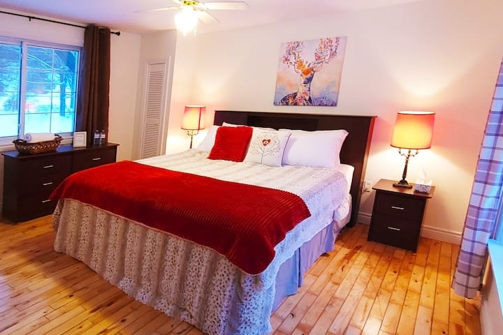 Large master bedroom with ultimate luxury bedding with a nice touch that makes falling asleep a cozy, comfortable experience.