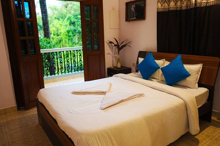 Bedroom 2 with AC, attached bathroom, and balcony