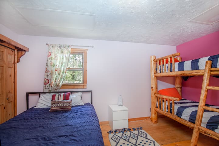 bunk beds and queen bed in this bedroom!