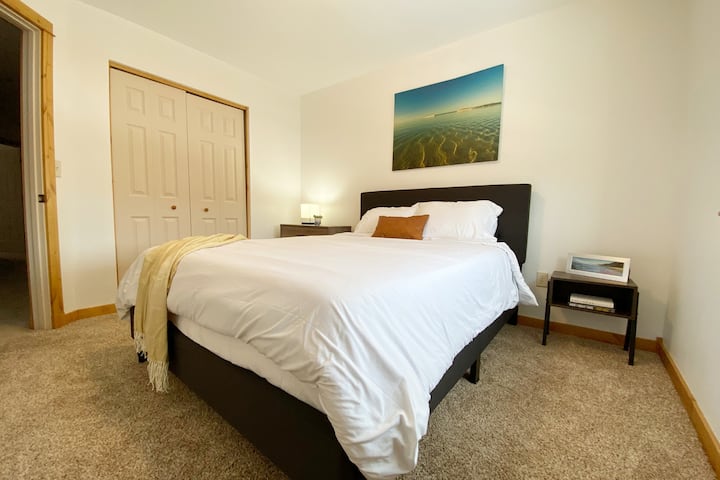 Each guest bedroom has a new memory foam mattress and side tables for storage.