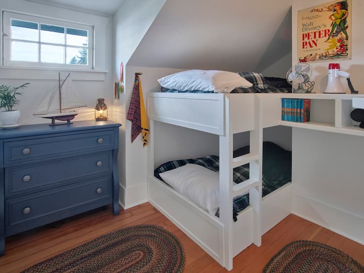 This darling bunk bed room is small and full of charm.  The bunk mattresses are extra long twins.