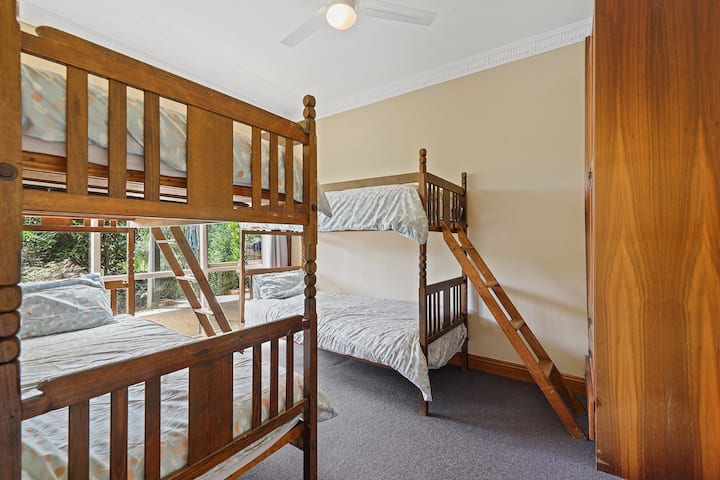 Bunk room, perfect for kids with 4 single beds. Plenty of storage available in this room with a large wardrobe & separate shelving