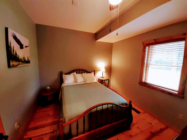 This room has a full size bed, is cozy and has some amazing paintings from Artist Loretta Greener.