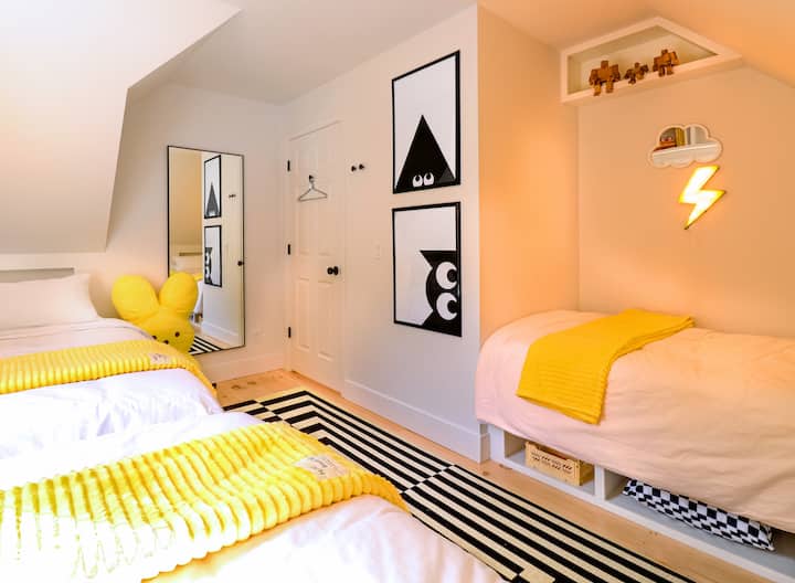 Lightening room with 3 twin beds. A graphic, cozy and fun room for all ages
