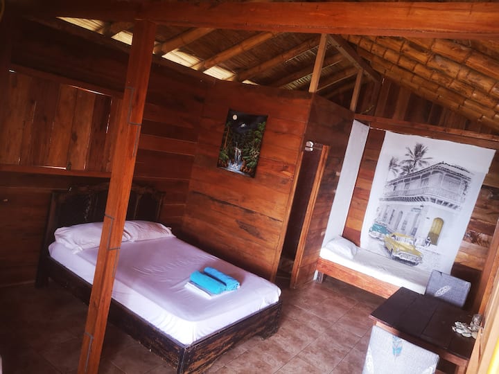 Descansa en una habitación rústica de madera con comodidades modernas, fusionando lo natural con el confort.