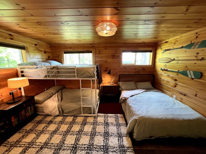 Bunkroom wide angle. All beds are size double. There's a half-bathroom just to the right of the photo accessed from within the room. A closet is to the left where we keep a portable crib.