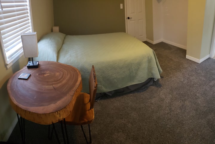 This primary bedroom is spacious and has a desk and chair, great for working remotely.