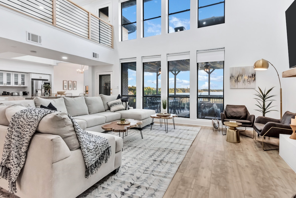 Open-concept living space with soaring ceilings and lake views