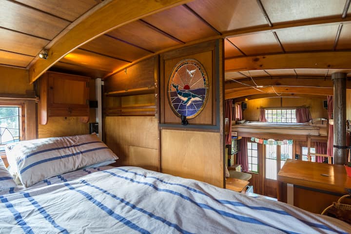 Main queen size bed above truck cab. Ladder access.