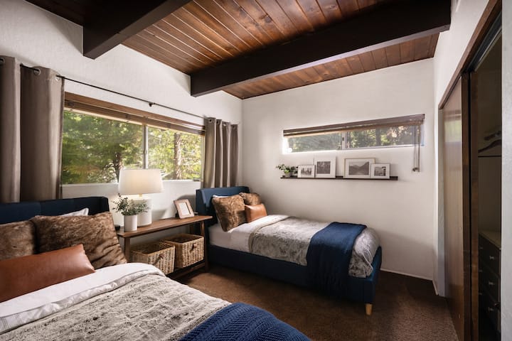 The twin room is just off the entry level den with closet and wooded views