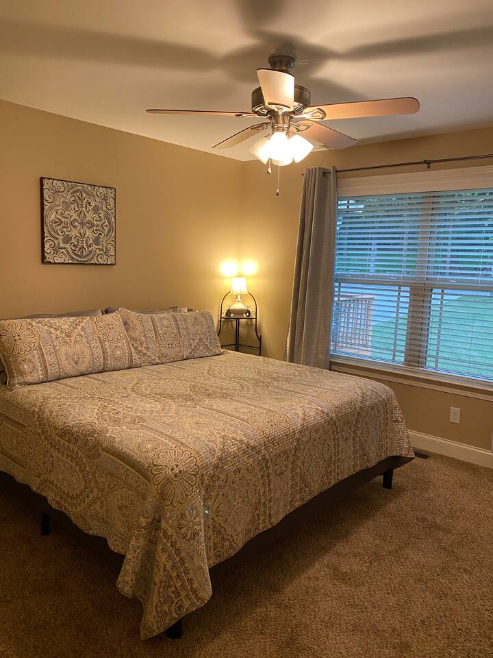 Large bedroom with King Size bed with blackout curtains. 