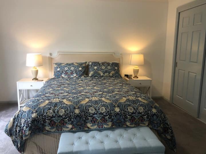 The bedroom has comfortable queen size bed and designer furniture and bedding.