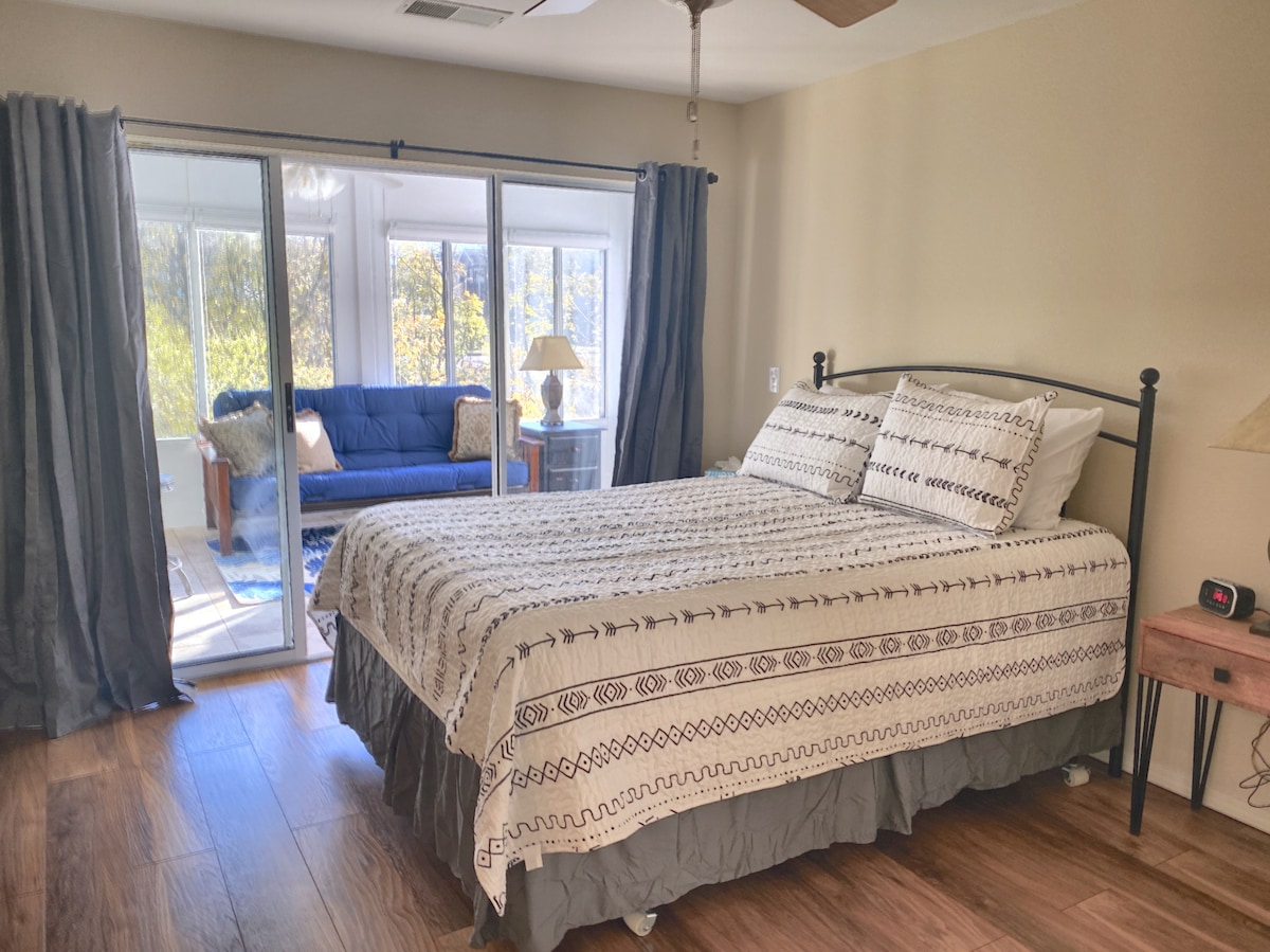 The master bedroom is large, has an ensuite bathroom, and has direct access to the sunroom. 