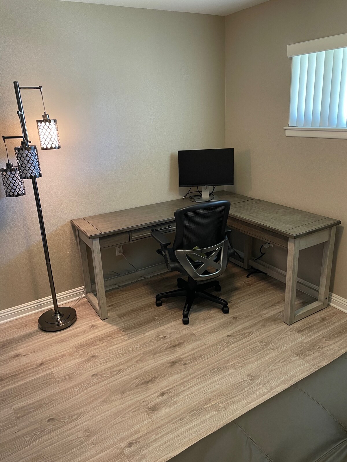 Dedicated office with large L-shaped desk and lamp. A Euro Lounger gives you another place to relax and will add another sleeping option. 