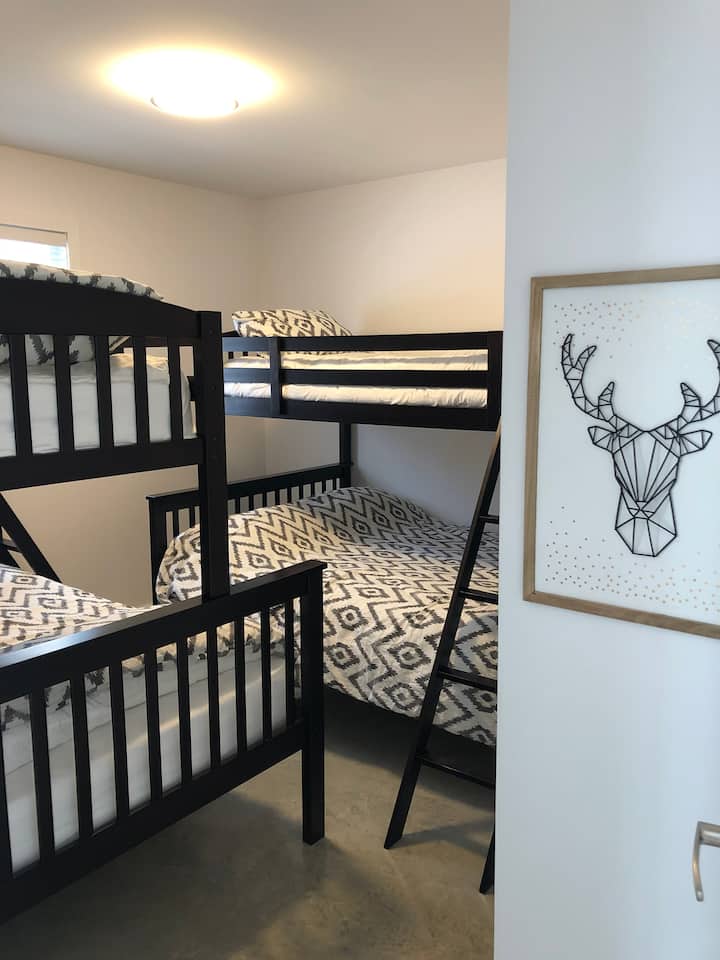 Bedroom 2 including 2 double bunk beds at the bottom and single at the top