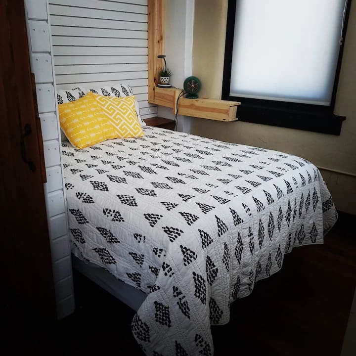 Queen bed with a sliding barn door to provide a bit of privacy. 