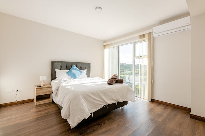 Bedroom with a queen size bed, view and air conditioning