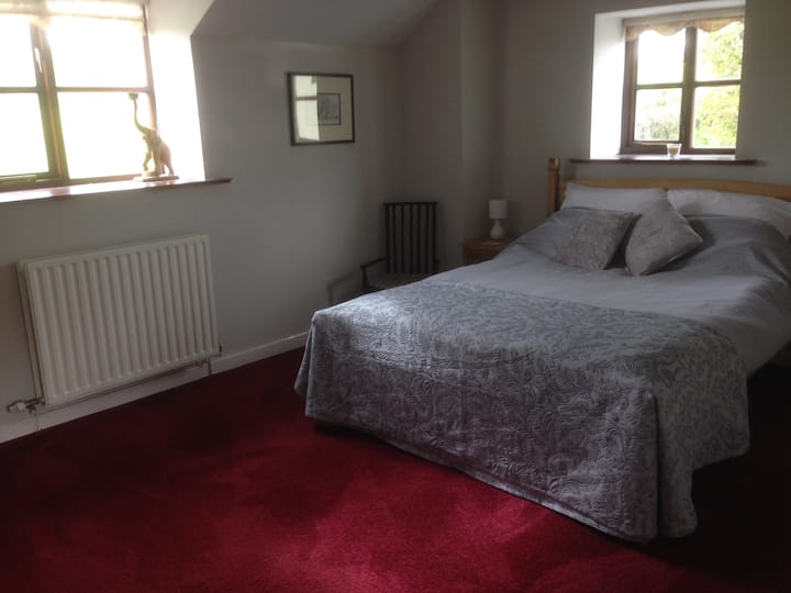 Bedroom 1- largest bedroom with king sized bed,  double fitted wardrobe/dressing room with 2 chest of drawers and a dressing table and mirror.  Windows with views over the surrounding fields.
Spare duvet and bed spreads on top shelf of wardrobe.