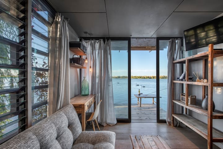 Completely self-contained, the boathouse sleeps up to two people.