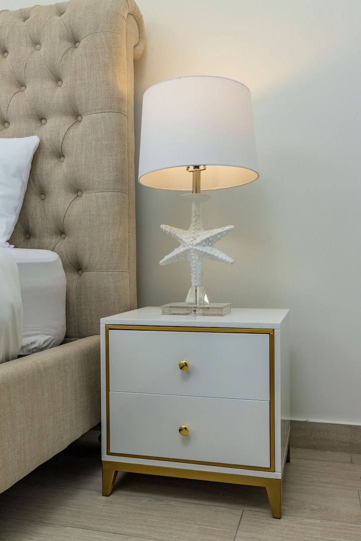 Inside this bedroom, there's a cool lamp decor on top of the nightstand that always reminds you of the beach.