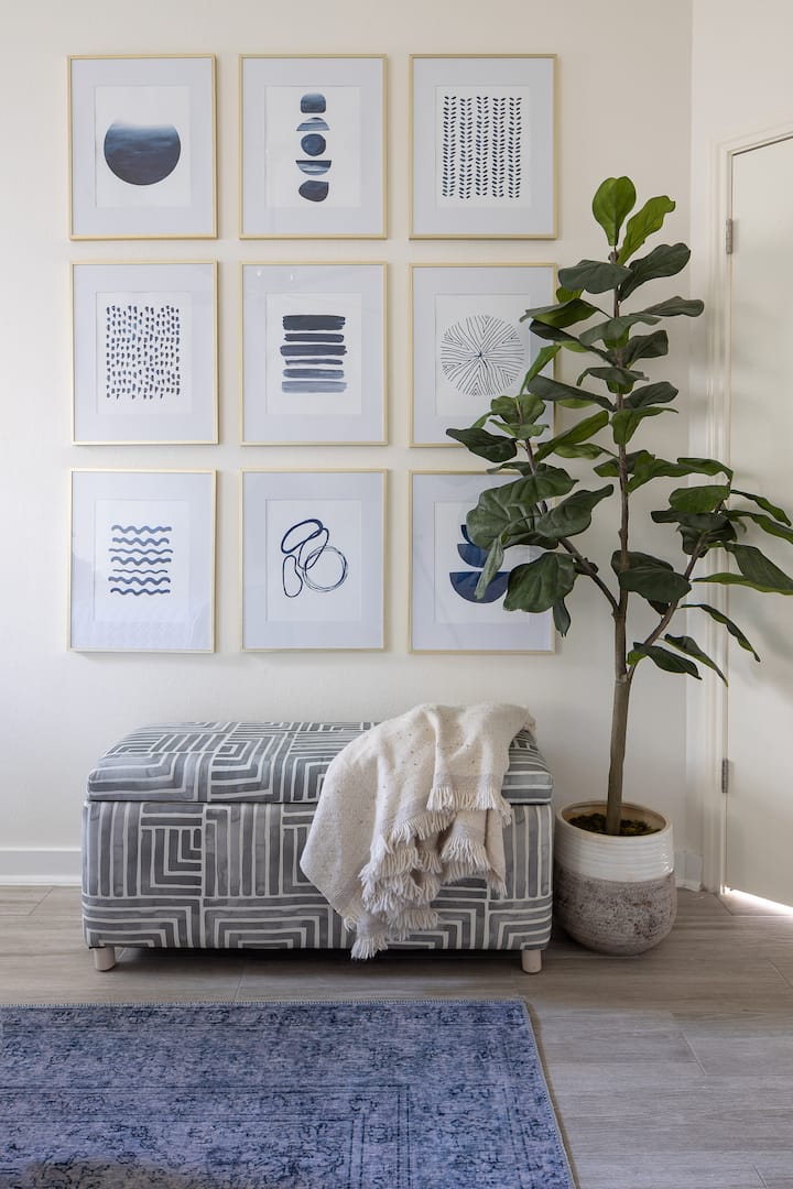 The master bedroom is nestled behind the living room, has a large wall-in closet, and en suite equipped with a soaker tub for those who enjoy taking a relaxing bath. Each bedroom has luxe bedding and finishes. 