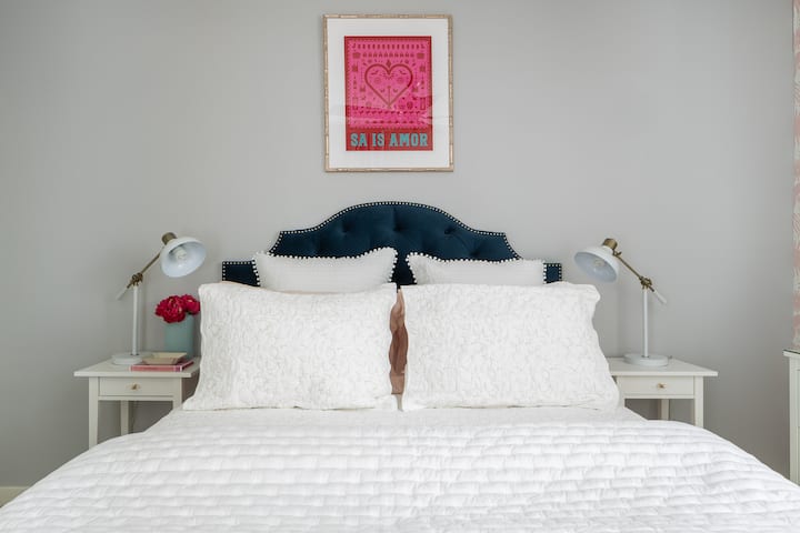 The pink room is fun and fit for a fashionista. There's local artwork on the walls, along with a bench window nook. 