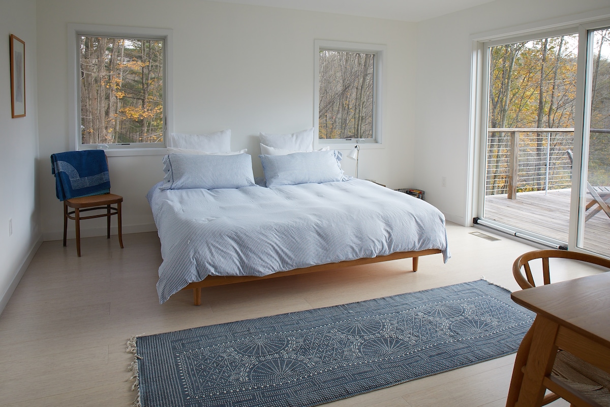 Primary bedroom with private balcony with mountain views.