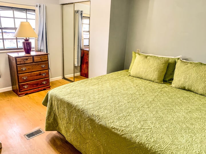 Main bedroom with king sized bed and half bath.