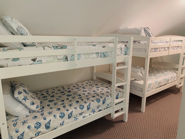 Twin bunk beds in upstairs hallway common area
