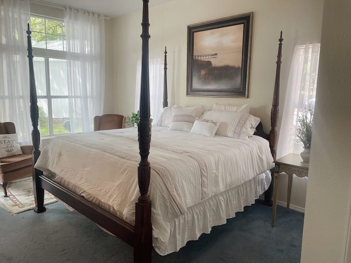 Master  bedroom with king-sized bed and lake views and outdoor patio access