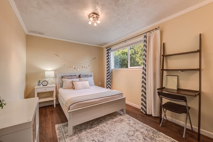 4th bedroom with full bed and small desk space.