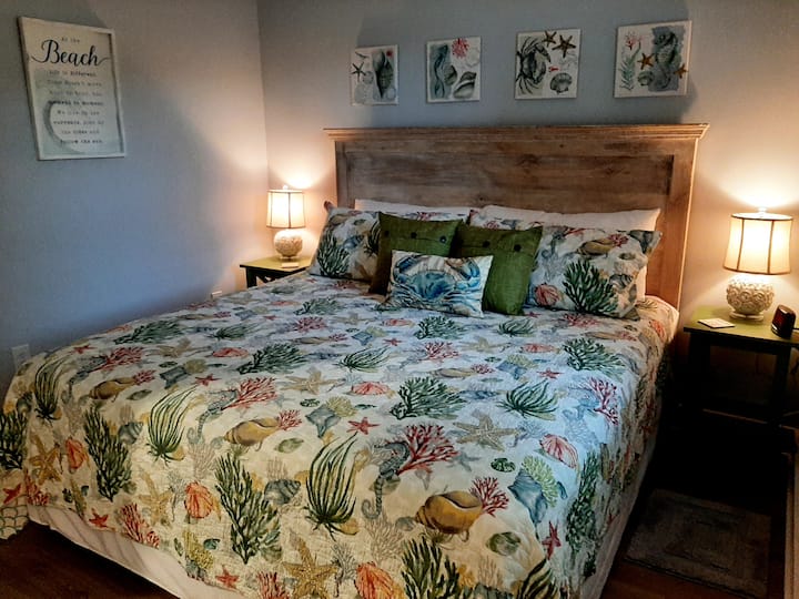 King Bedroom, view of Lighthouse, attached to Hall Bath, ceiling fan and Smart TV on wall