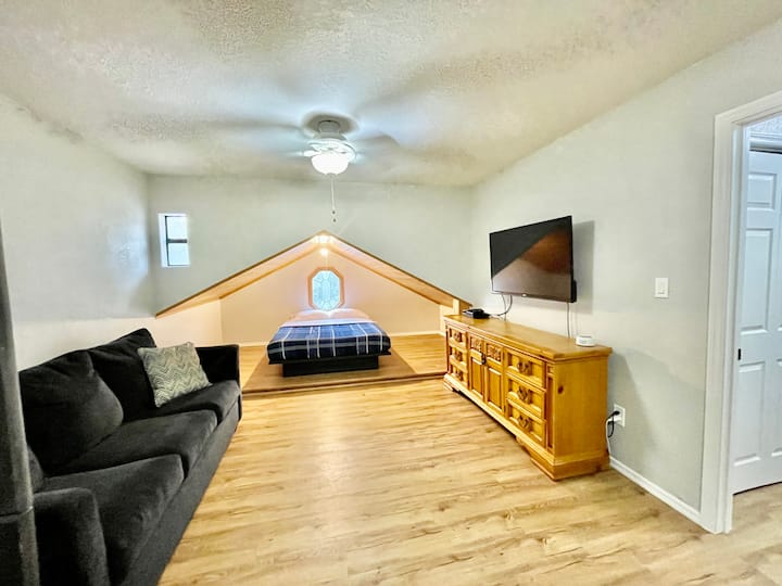 Loft bedroom with bed, bunkbeds and couch